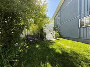 View of grassy yard with stairway