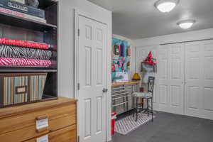 Bedroom with a textured ceiling and a closet