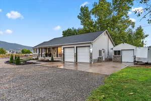 Ranch-style house with a mountain view, stone siding, and a porch