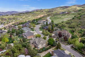 Aerial view of property's location featuring nearby suburban area and a mountainous background