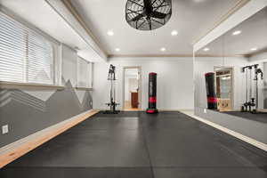 Workout area with baseboards, recessed lighting, and ornamental molding