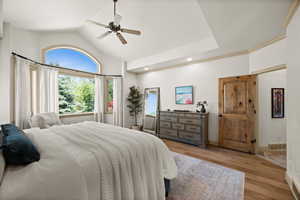 Bedroom featuring wood finished floors, a ceiling fan, recessed lighting, high vaulted ceiling, and baseboards