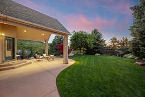 Yard at dusk with a patio area