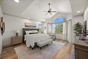 Bedroom with light wood-type flooring, vaulted ceiling, recessed lighting, a ceiling fan, and baseboards
