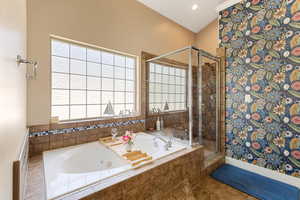 Ensuite Bathroom with a double vanity, relaxing jacuzzi, an enclosed shower, and a walk-in closet.