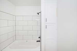 Bathroom featuring washtub / shower combination
