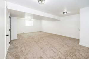 Basement featuring carpet and baseboards