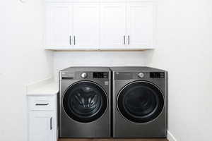 Laundry area with cabinet space and washing machine and clothes dryer