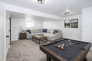 Playroom with carpet floors and pool table