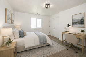 Bedroom with carpet flooring and an office area