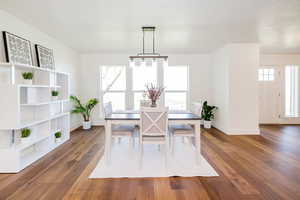 Dining space with baseboards and wood-type flooring
