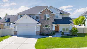 Craftsman-style home with stone siding, driveway, an attached garage, and a shingled roof