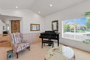 Sitting room featuring light carpet, lofted ceiling, and recessed lighting