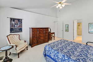 Bedroom featuring carpet flooring, baseboards, high vaulted ceiling, and a ceiling fan