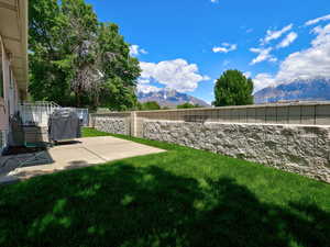 View of yard featuring a mountain view and a patio area
