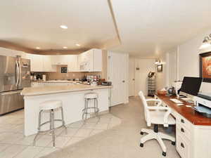 Home office with recessed lighting, a sink, and light tile patterned flooring