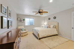 Bedroom with carpet floors, baseboards, and ceiling fan