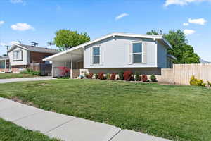 Split level home featuring concrete driveway, a carport, and brick siding