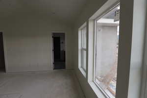 Spare room with vaulted ceiling