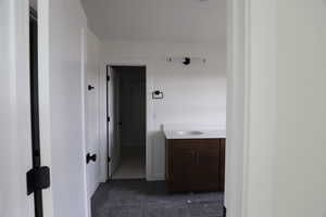 Hall with dark tile patterned flooring