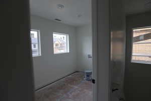 Bathroom featuring plenty of natural light and baseboards