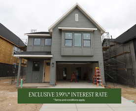 View of front of property featuring an attached garage and fence