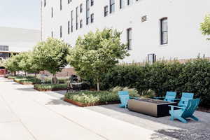 View of home's community with a fire pit and a patio