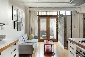 Living area featuring light wood-type flooring and french doors