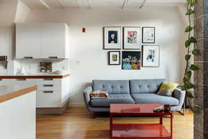 Living area with baseboards and light wood finished floors