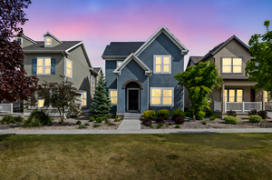 Traditional home with stucco siding and a yard