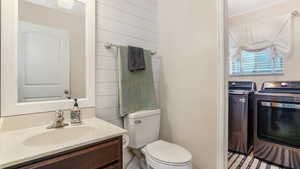 Half bathroom featuring toilet and vanity