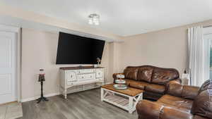 Living room featuring wood finished floors and baseboards