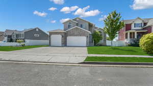 View of front of house featuring a garage, driveway, and a residential view