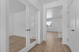 Hall featuring wood finished floors and baseboards