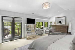 Bedroom with access to outside, carpet flooring, french doors, vaulted ceiling, and a chandelier