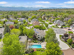 Aerial view of residential area with mountains and a pool