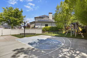 View of sport court with a playground and basketball hoop