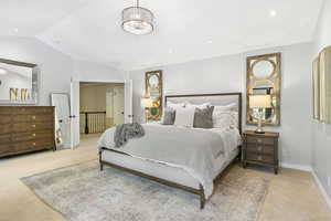 Carpeted bedroom featuring lofted ceiling, baseboards, a chandelier, and recessed lighting