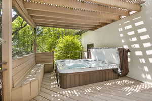 Wooden deck featuring a hot tub