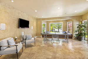 Office space with stone tile floors, recessed lighting, a baseboard radiator, and baseboards