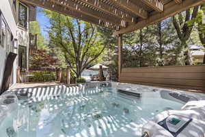 View of swimming pool featuring a hot tub