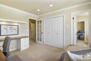 Home office with ornamental molding, recessed lighting, light carpet, baseboards, and french doors