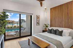 Bedroom featuring access to outside, wood finished floors, ceiling fan, and recessed lighting