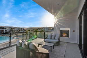 Balcony featuring a high end fireplace and a residential view