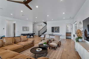 Living area with light wood finished floors, stairway, recessed lighting, billiards table, and baseboards