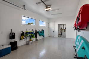 Garage with a garage door opener and baseboards