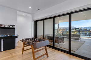 Rec room featuring light wood-style flooring and recessed lighting