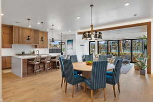 Dining space featuring plenty of natural light, recessed lighting, and light wood-style flooring