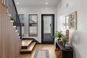 Doorway to outside featuring wood finished floors and recessed lighting