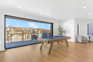 Game room featuring billiards, wood finished floors, recessed lighting, a textured ceiling, and baseboards